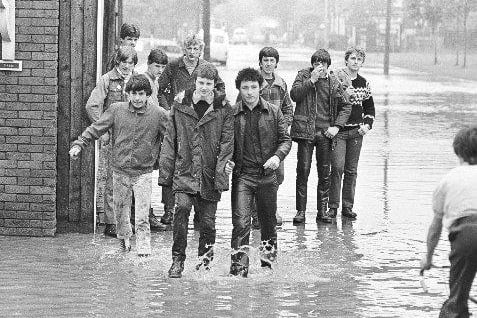 The lads wading through floodwater
