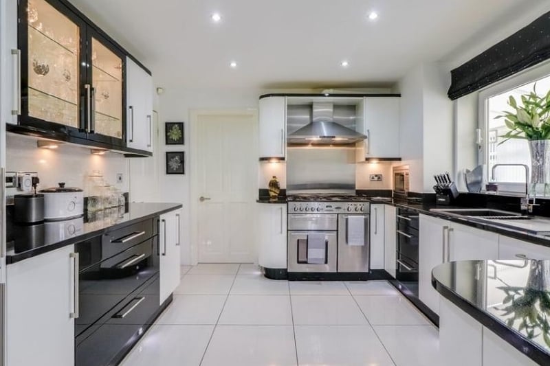 Integrated appliances including microwave, dishwasher and fridge, tiling to the floor, UPVC double glazed sliding window to the conservatory, plinth lighting, open archway with gated access leads into the utility room.