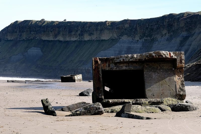 The concrete World War Two defence stations strewn on the beach at Cayton Bay.