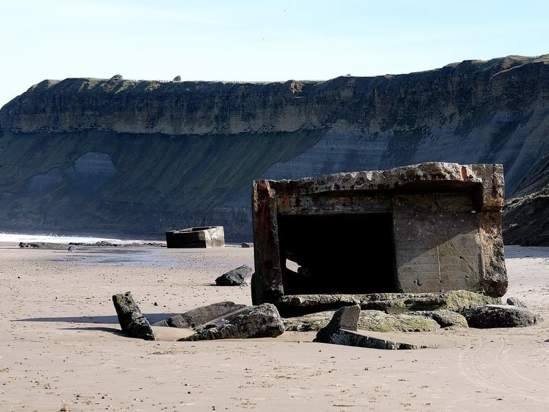 The concrete World War Two defence stations strewn on the beach at Cayton Bay.