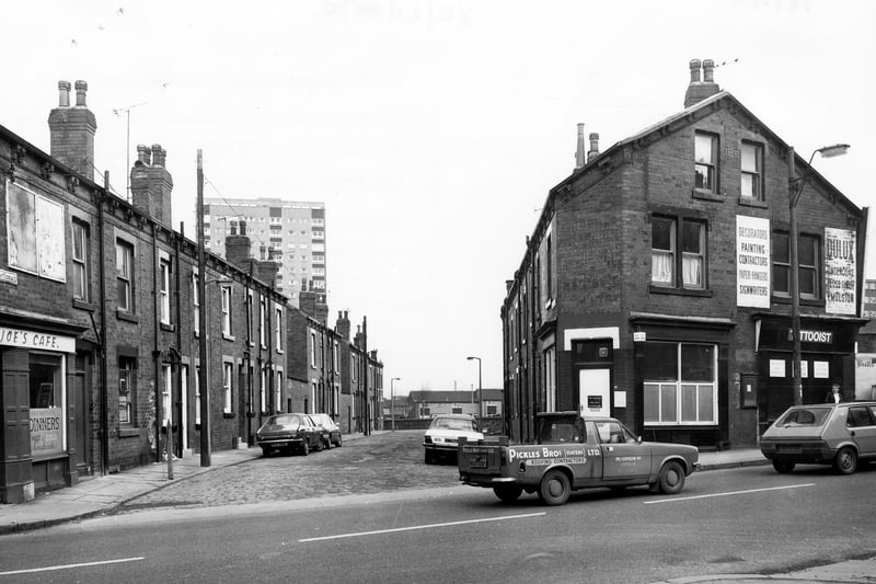 Domestic Street showing the junction with Pleasant Terrace in February 1980. Joe's Cafe, no. 71 Domestic Street, is on the left. A tattooist's shop is on the right.