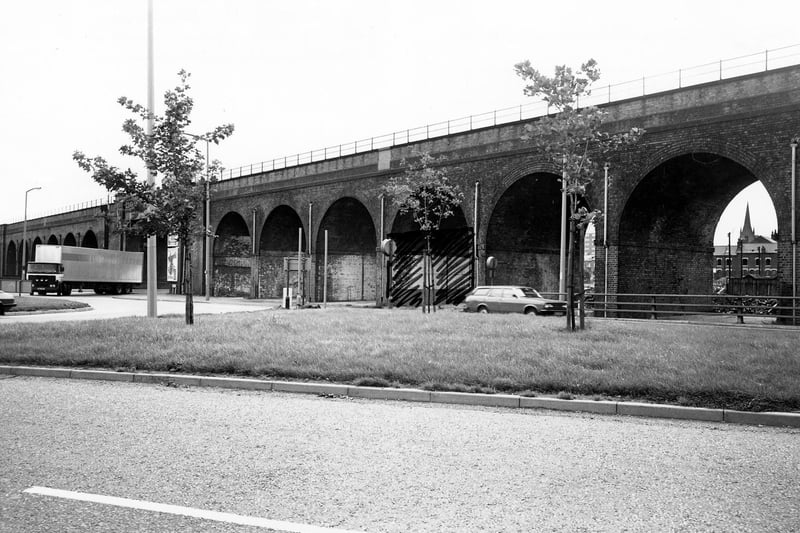 The railway viaduct on Domestic Street pictured in February 1980. The spire of St. Matthew's Church can be seen through the arch on the right.