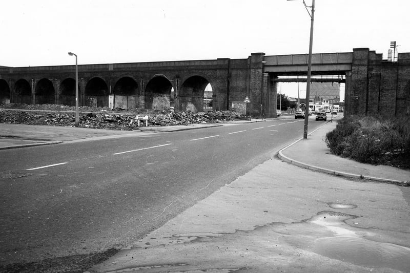 The railway viaduct crossing Domestic Street in February 1980. The old junction with Ingram Road is on the left, which was to be developed as Ingram Gardens and Ingram Close. A gasometer can be seen in the distance through the archway.