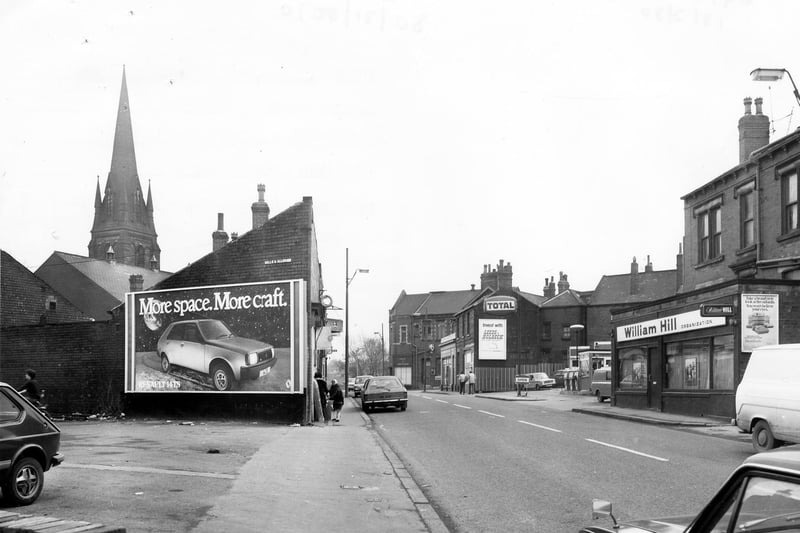 Febraury 1980 and on the right is William Hill, bookmakers followed by a petrol filling station. Advertising hoardings can be seen, including for Renault cars and the Leeds & Holbeck Building Society.
