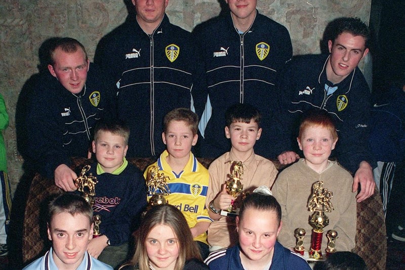 December 1999 and Leeds United academy stars Lennie Walker, Chad Harper, Craig Farrell and Fraser Richardson present trophies to Armley Juniors at Upstairs Downstairs Club.