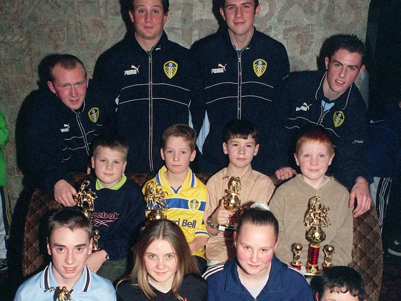 December 1999 and Leeds United academy stars Lennie Walker, Chad Harper, Craig Farrell and Fraser Richardson present trophies to Armley Juniors at Upstairs Downstairs Club.