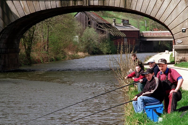 Gone fishing. Andrew McGlinchy (front) tries his luck on the Leeds and Liverpool Canal at Armley with angling expert Adam Speight looking on.