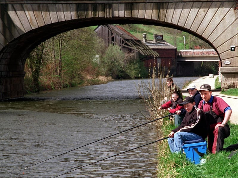 Gone fishing. Andrew McGlinchy, pictured front, tries his luck on the Leeds and Liverpool Canal with angling expert Adam Speight looking on.