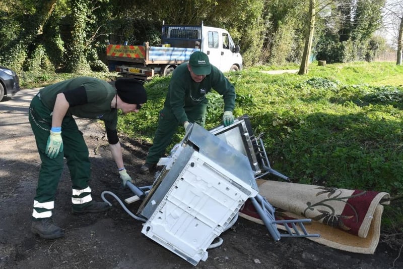 Council official remove items that have been fly tipped at Frenchwood Recreational Ground in Preston