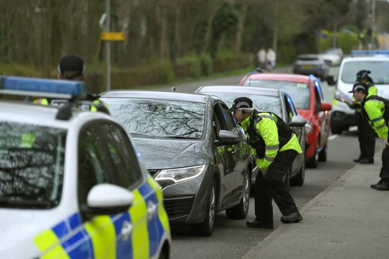 Police officers stop motorists on Garstang Road in Fulwood to check that their travel is essential