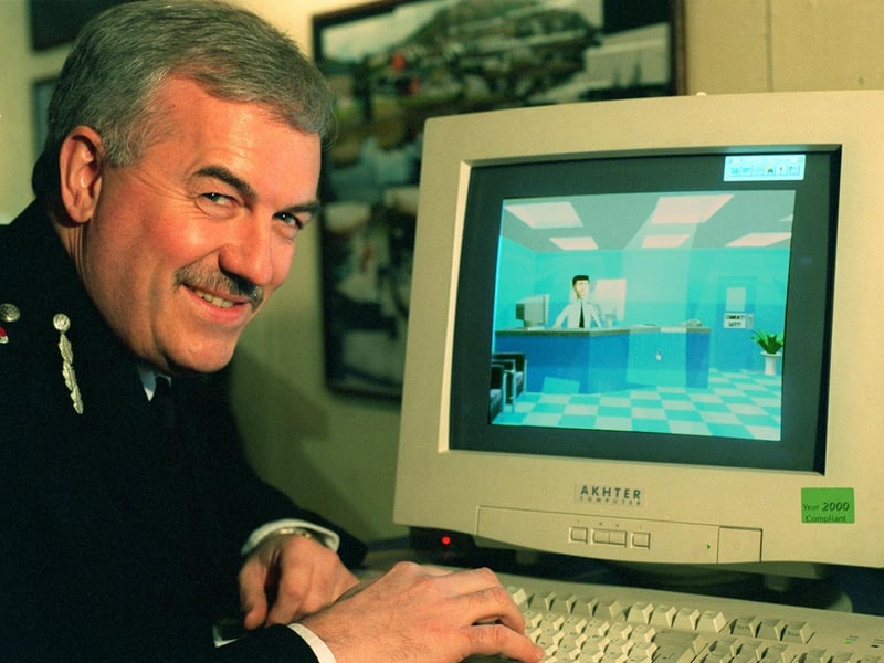 The Chief Constable of West Yorkshire Police, Graham Moore with a new West Yorkshire Police CD ROM that includes a virtual reality police station.