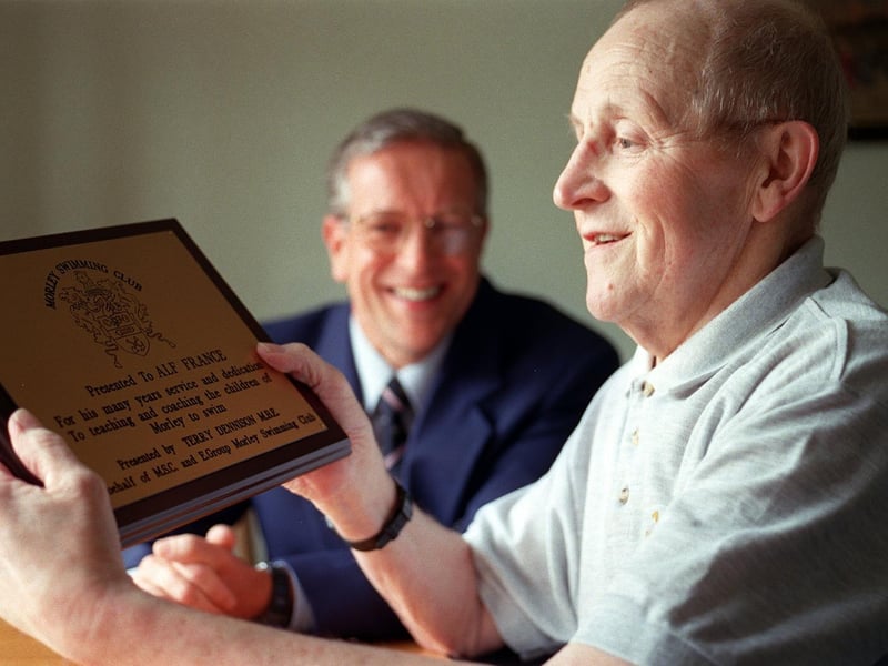 Swimming coach Alf France receives a plaque from City of Leeds swimming coach Terry Dennison for his service to the sport.