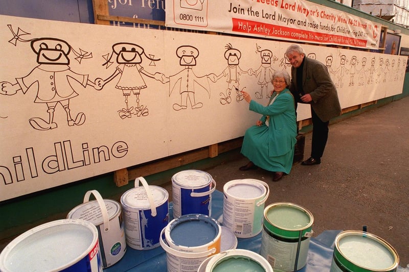 Artist Ashley Jackson and the Lord Mayor of Leeds Coun Linda Middleton with a 30ft mural to raise funds for Childline outside the Debenham's store on Briggate.