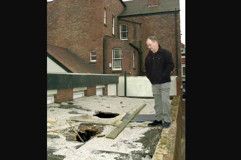 Landlord of the George Hotel on Central Drive Bruce Falconer looking at a vandalised garage roof