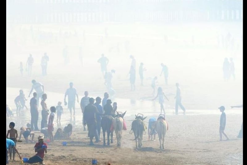 A display's smoke fumes create a fog on the beach