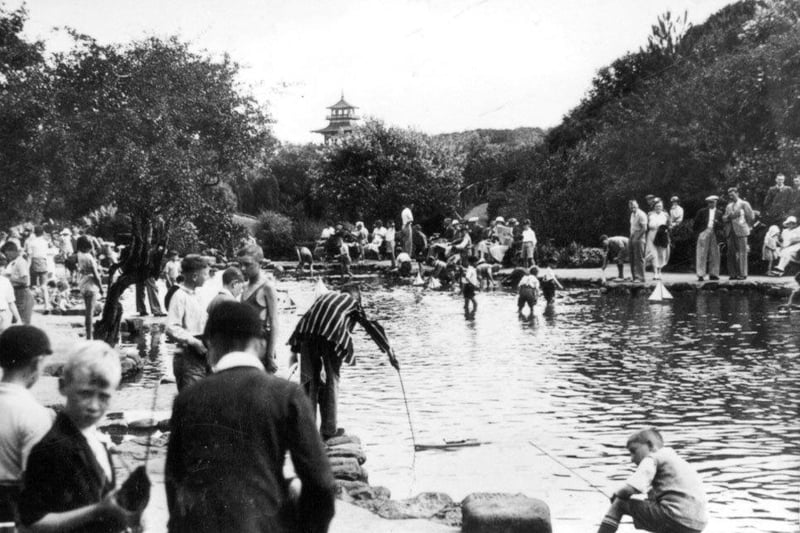 The children' yachting pool being enjoyed by many children and adults, the pagoda can be seen in the distance.