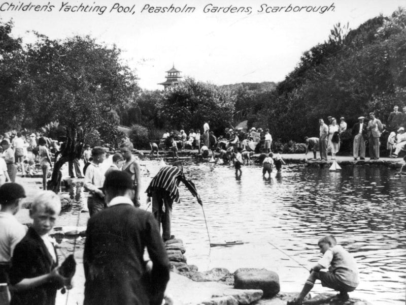 The children' yachting pool being enjoyed by many children and adults, the pagoda can be seen in the distance.