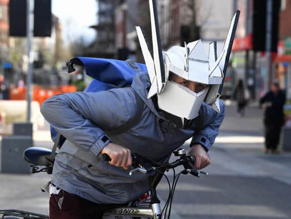 A cyclist with a unique take on safety with a home made helmet with built in face mask