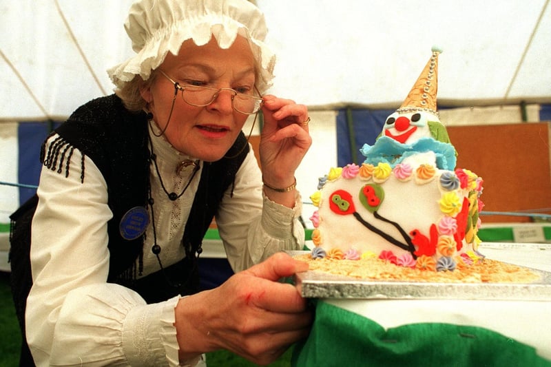 May 1996 and Otley Show steward Nora Hawkins from Leathley admires one of the novelty cakes on display.
