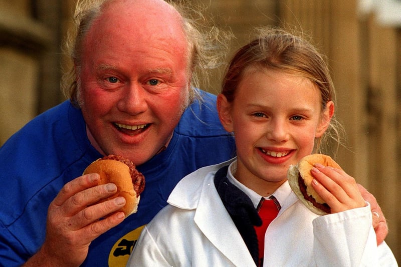 Grumbleweed and local farmer Graham Walker samples a burger with Victoria Lister, a member of the Askwith Young Farmers, in Otley on British Beef Day in October 1996.
