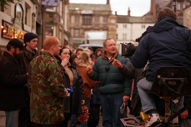October 1996 and Emmerdale cast members are briefed before a film shoot in the town's Market Square.