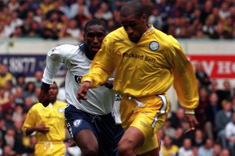 Brian Deane pushes forward with Tottenham Hotspur's Sol Campbell in pursuit.