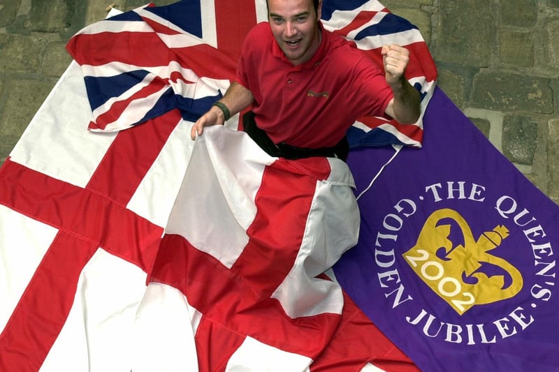 May 2002 and Paul Arthurs, sales exectutive at Union Industries in Hunslet, is pictured with some of rthe flags that are in huge demand for the World Cup and Queen's Jubilee.