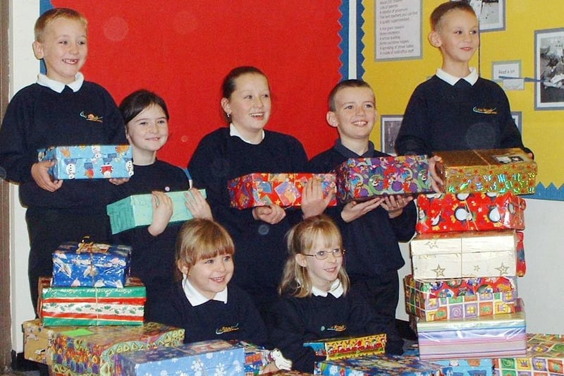 December 2002 and pupils at Low Road Primary are pictured with shoeboxes containing gifts collected for Operation Christmas Child.