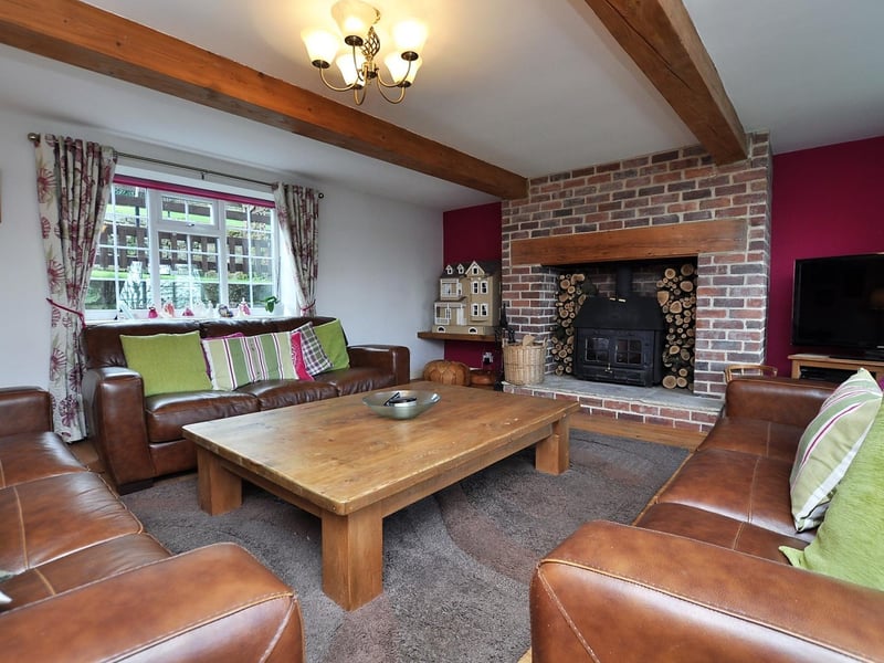 A large sitting room with stunning fireplace