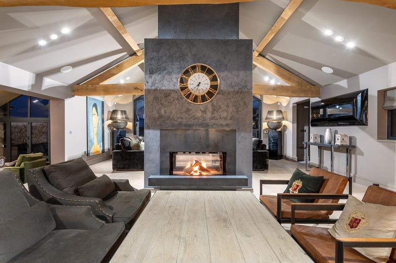 The double-sided fire and chimney create a division in the open plan area