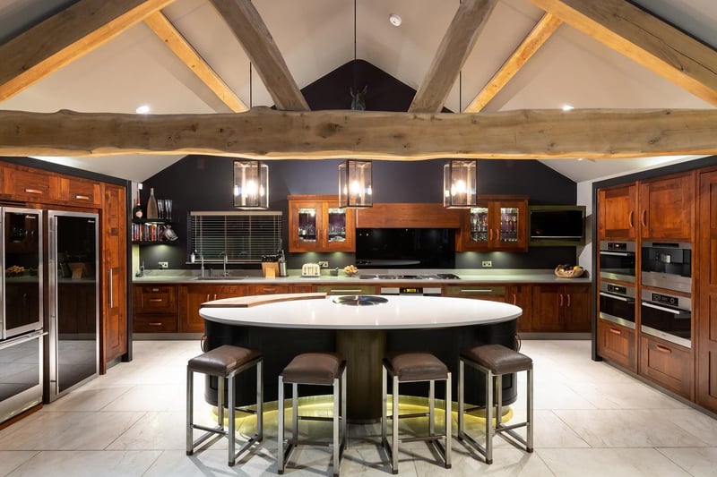The curved kitchen island softens the space