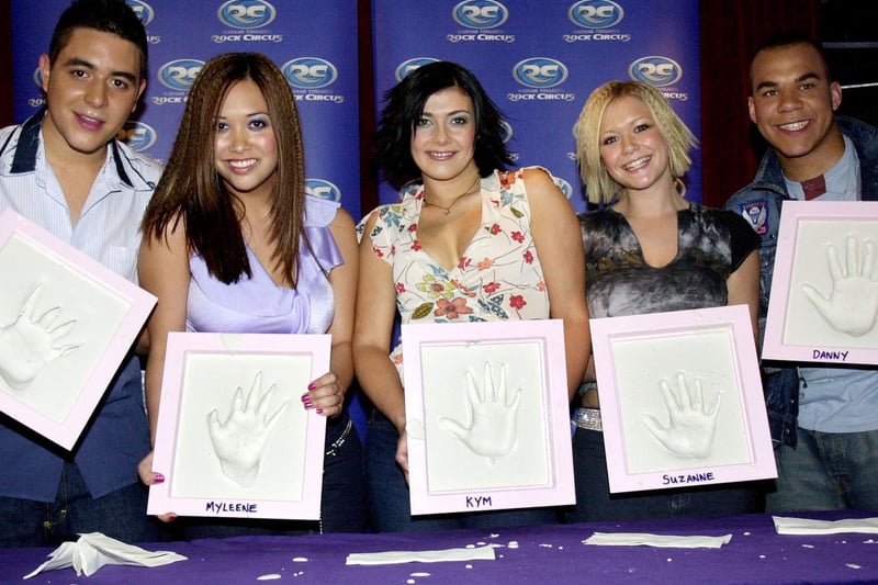 Members of the Pop group Hear'Say pose for a photograph with their hand casts for Rock Circus Wall of Hands on June 26, 2001, at Rock Circus, London.