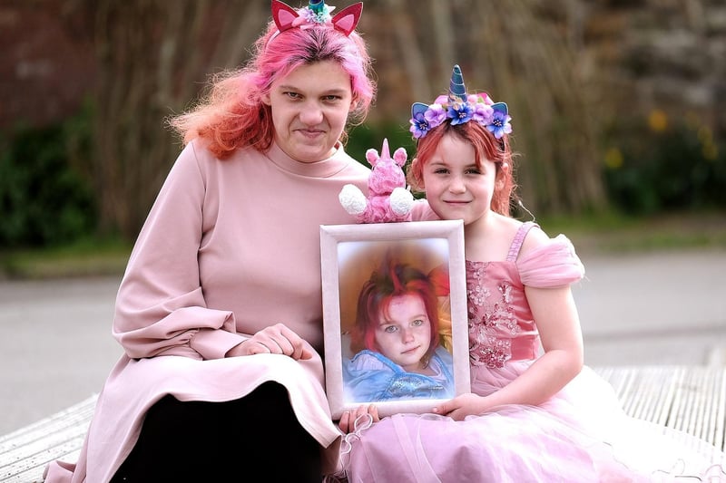 Mum Kelly and daughter Daisy with a picture of Jess.