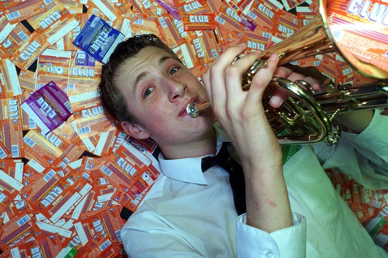 Cornet player Mark Howorth celebrates Guiseley School eating through 17,000, chocolate bars in exchange for musical instruments.
