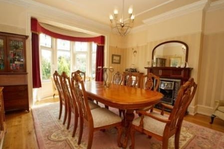 Double glazed bay window, feature gas fireplace with a wood surround, solid oak wooden flooring, picture rail, radiator with an ornate wooden cover, detailed cornicing and ceiling, serving hatch to the kitchen.