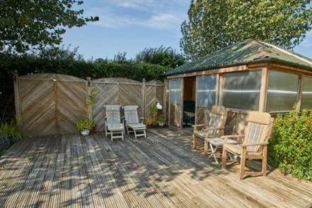 A summer house has been built at the bottom of the garden, complete with decking.
