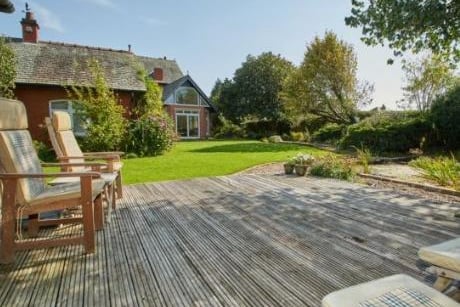 The rear South Facing Garden, which backs directly onto Green Belt, has various areas including a superb sunny decking area and a play area for children.