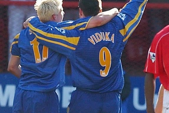 Mark Viduka celebrates with Alan Smith after scoring his third goal and Leeds United's fifth.