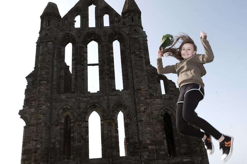Visitor Lucy leaps for joy as the Abbey reopens.