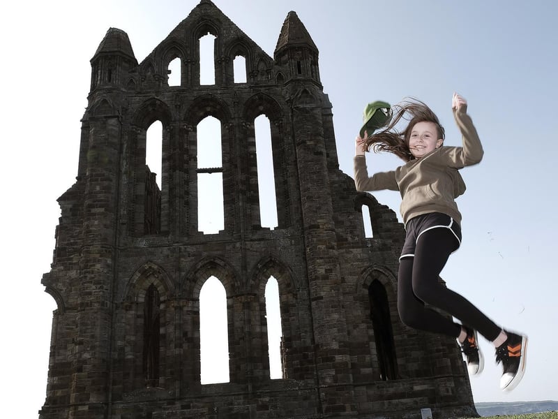 Visitor Lucy leaps for joy as the Abbey reopens.