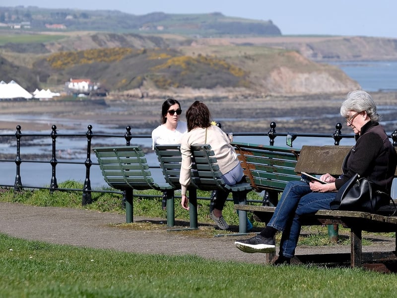 Enjoying a catch up in the sun on Queen's Parade.