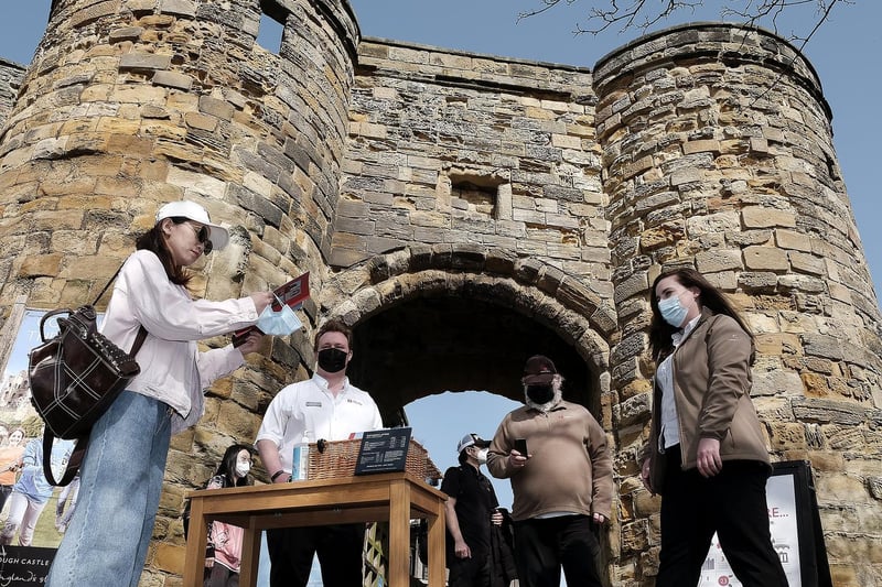 Visitors arrive at Scarborough Castle as Manager Charlotte Hanson greets them at the entrance.