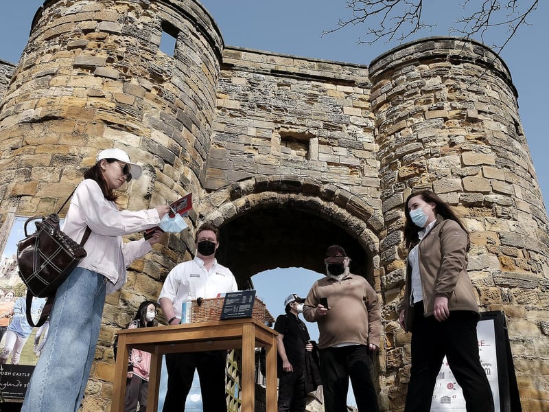 Visitors arrive at Scarborough Castle as Manager Charlotte Hanson greets them at the entrance.