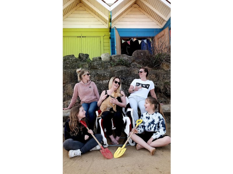 A family relax by their chalet.