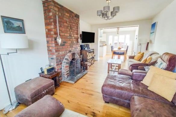 The generous sized lounge is bursting with character, with a feature wood panelled wall to the front and a bay window. The exposed chimney breast houses a working fire.
