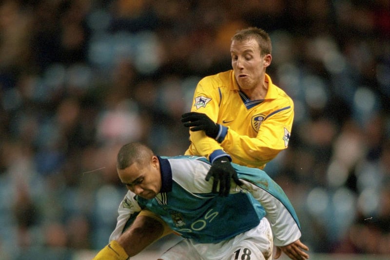 Manchester City's Jeff Whitley holds off Lee Bowyer.