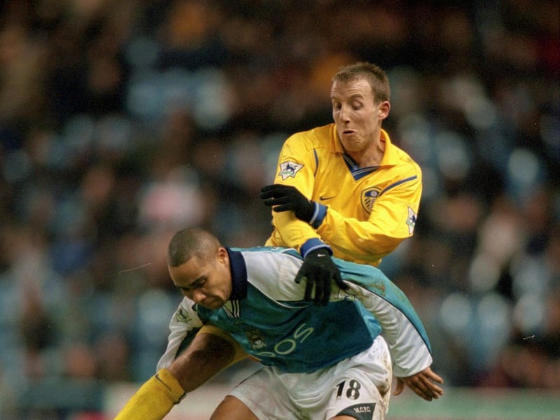 Manchester City's Jeff Whitley holds off Lee Bowyer.