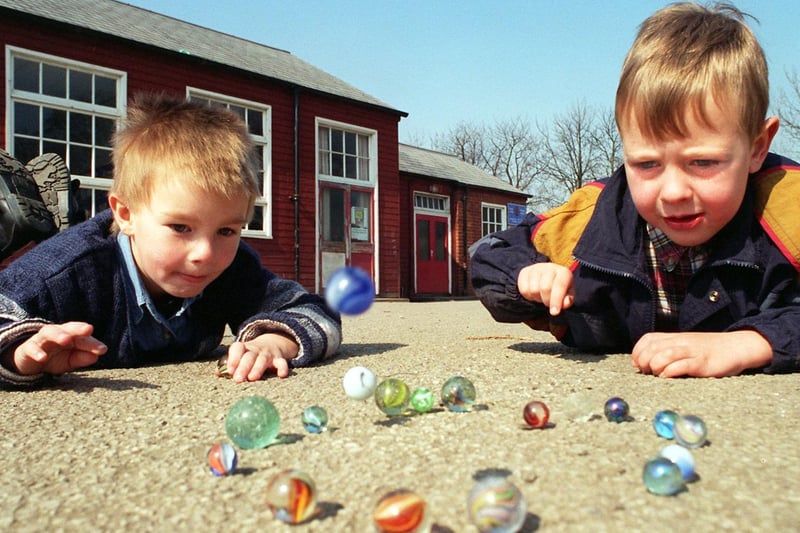 Jack Carrack (left) and friend Jonathan Hill practise marbles on their school playground in Leeds during the Easter holidays.