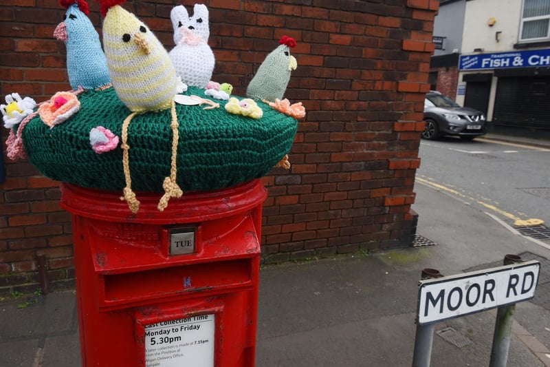 A crocheted bonnet with knitted animals has been made for the post box on Moor Road, on junction of Church Street, Orrell, thought to be part of an Easter trail.