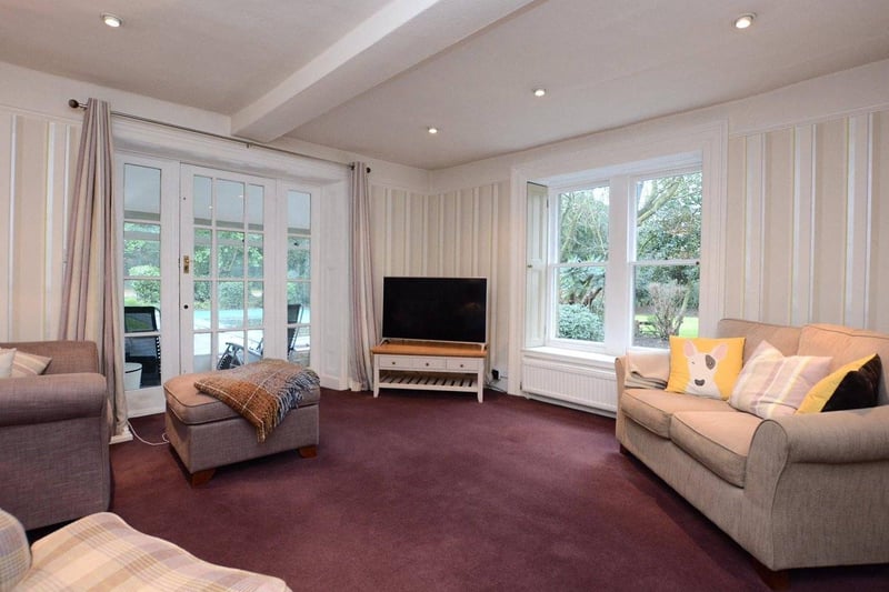 A further sitting room features a pebble effect gas fire and a glazed door leading into a conservatory, which overlooks the formal gardens, tennis court and swimming pool.